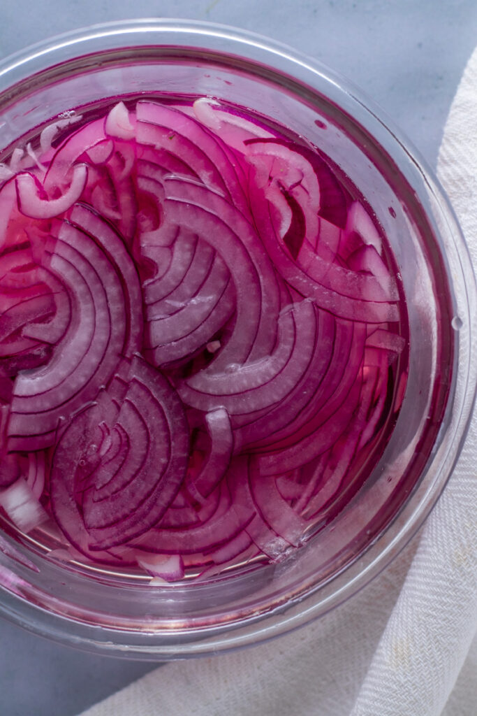 Red Onions in pickling liquid.